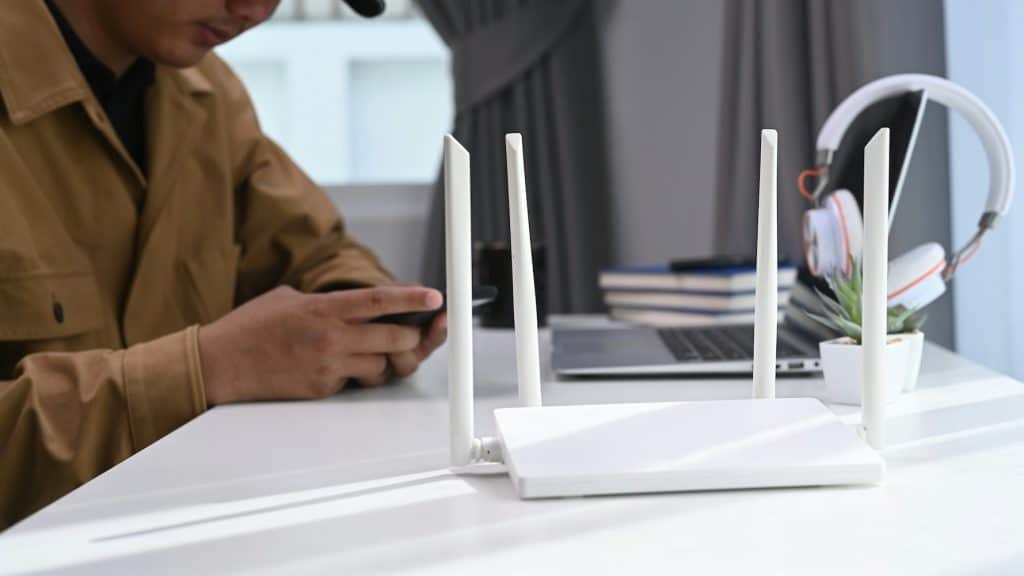 Close-up of a WiFi router on a desk, representing issues like dead zones and inconsistent coverage in commercial spaces.